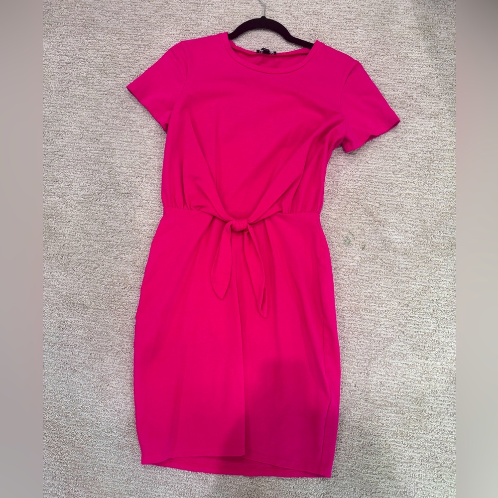 Pink short sleeve midi dress with knot detail on the front. Worn one time.